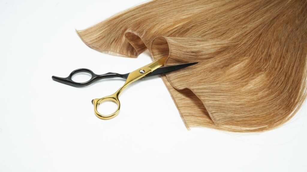 A pair of scissors about to cut a Genius Weft from the Spine